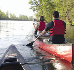 A couple in paddles their canoe in a Georgia river